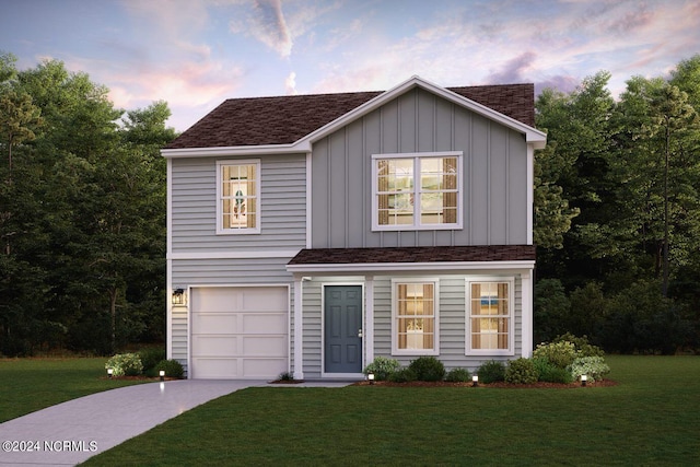 view of front of house featuring a lawn and a garage