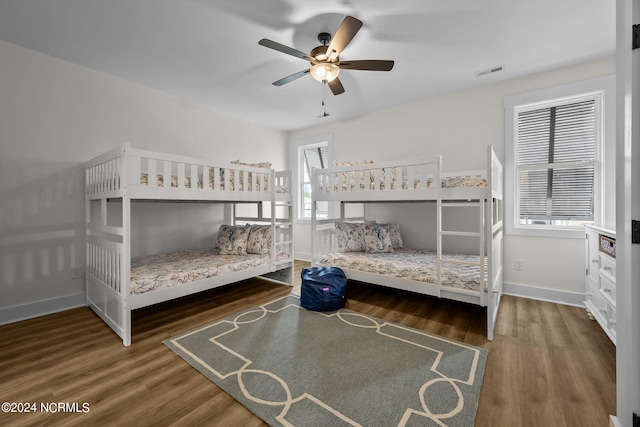 bedroom with dark hardwood / wood-style floors and ceiling fan