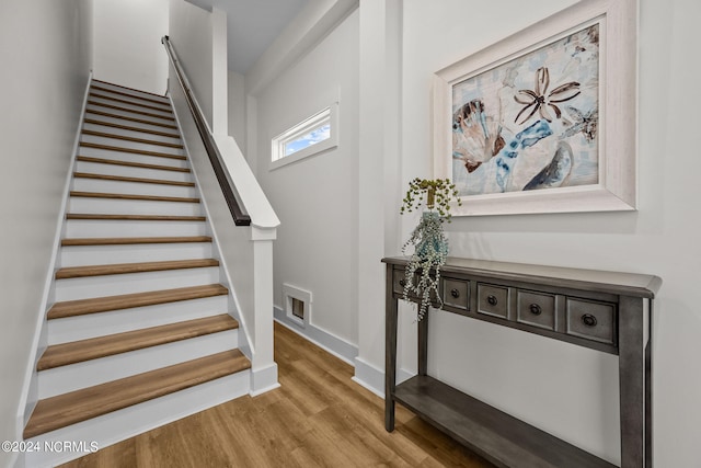 staircase with wood-type flooring