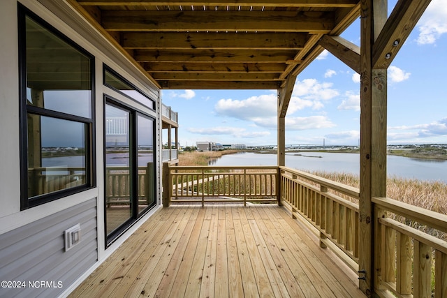 wooden deck featuring a water view