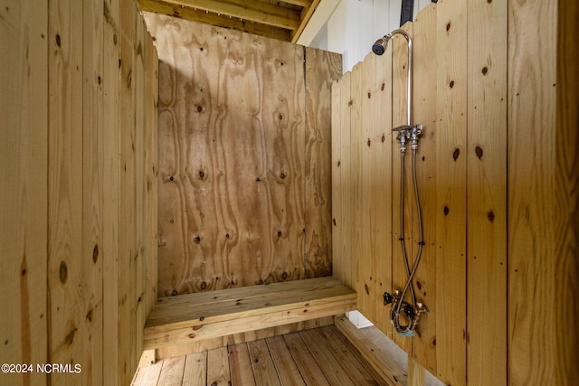 view of sauna featuring wooden walls and hardwood / wood-style flooring