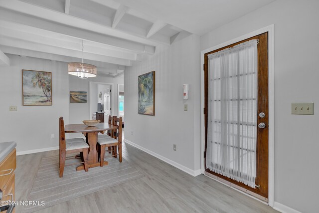 dining area featuring beamed ceiling, sink, light wood-type flooring, and ceiling fan