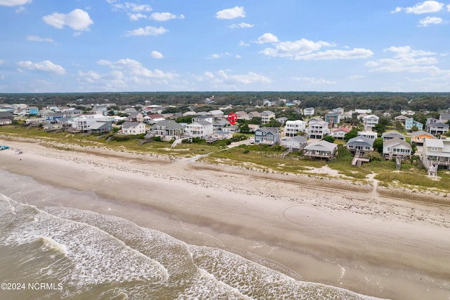 birds eye view of property featuring a water view and a view of the beach