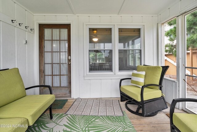 back of property featuring a yard and a sunroom