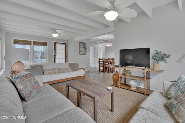 dining room featuring light hardwood / wood-style floors, a notable chandelier, and beam ceiling