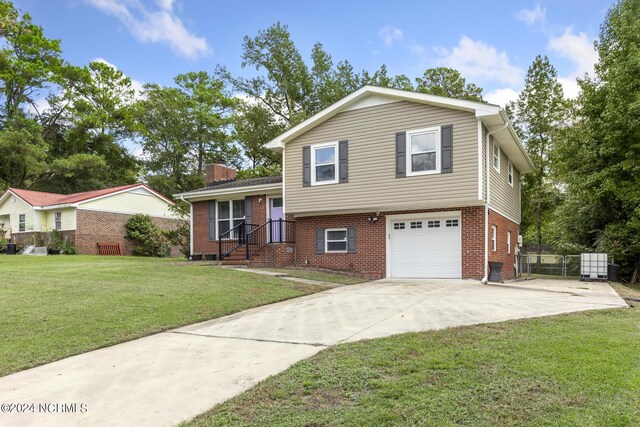 tri-level home with a garage and a front yard