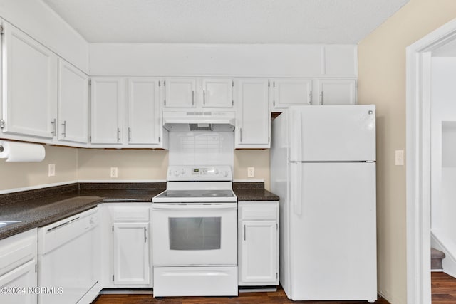 kitchen with white cabinets, a textured ceiling, dark hardwood / wood-style flooring, and white appliances