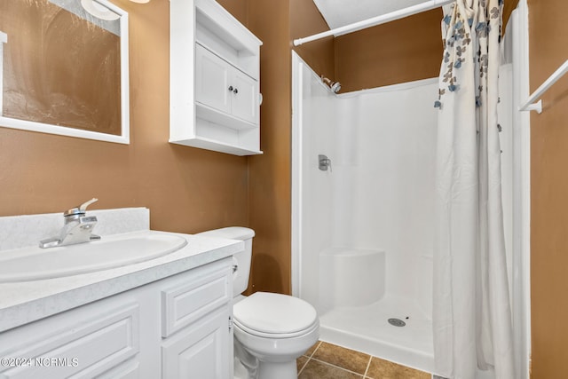 bathroom featuring tile patterned flooring, vanity, toilet, and a shower with curtain