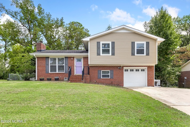 tri-level home featuring a garage and a front lawn