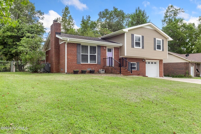 split level home with a front yard and a garage