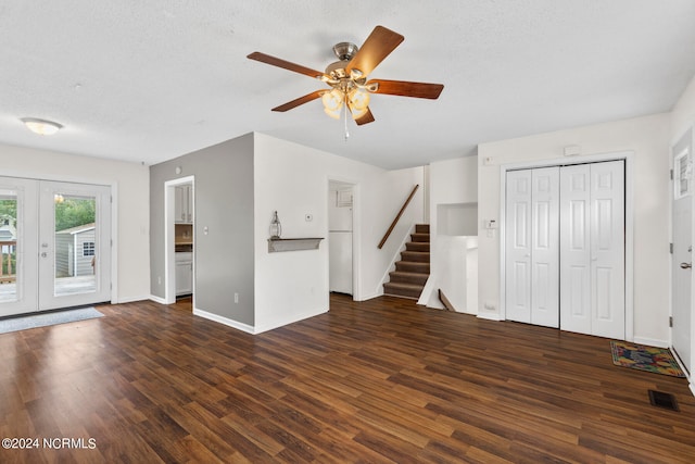 interior space featuring a textured ceiling, ceiling fan, dark wood-type flooring, and french doors