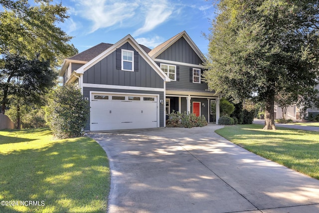 114 Castaway Cv, Cedar Point, NC 28584 - craftsman inspired home featuring driveway, board and batten siding, a front yard, covered porch, and an attached garage