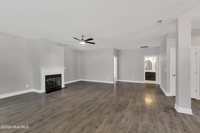 unfurnished living room with ceiling fan and dark hardwood / wood-style floors