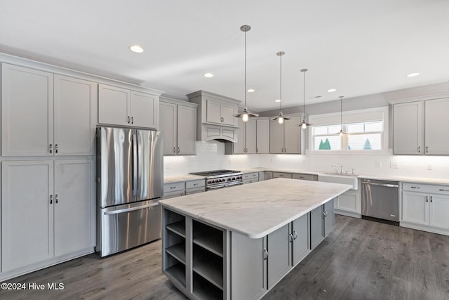 kitchen featuring gray cabinetry, a center island, stainless steel appliances, dark hardwood / wood-style flooring, and pendant lighting