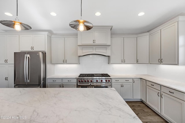 kitchen with decorative light fixtures, dark hardwood / wood-style flooring, decorative backsplash, and appliances with stainless steel finishes