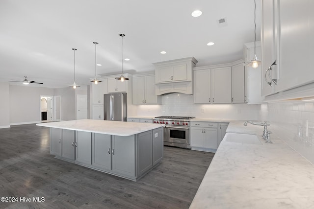 kitchen featuring backsplash, ceiling fan, dark wood-type flooring, and appliances with stainless steel finishes