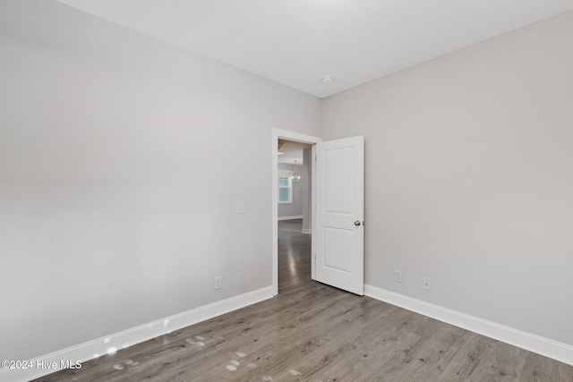 unfurnished room with wood-type flooring