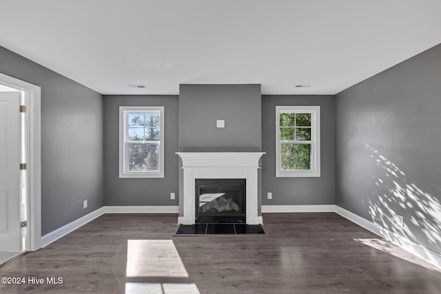 unfurnished living room with dark wood-type flooring