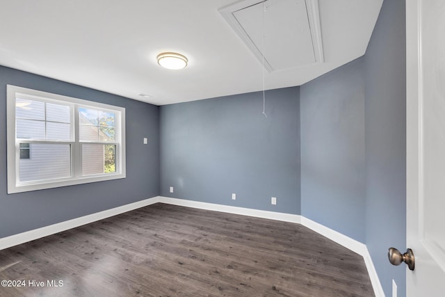 unfurnished room with dark wood-type flooring