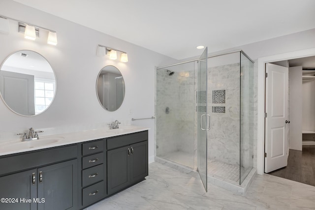 bathroom featuring wood-type flooring, vanity, and a shower with door