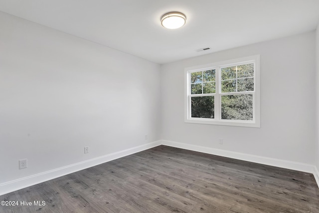 empty room with dark hardwood / wood-style floors