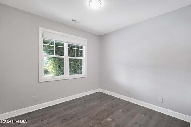 spare room featuring dark wood-type flooring