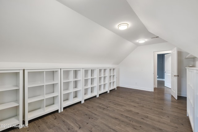 additional living space featuring dark hardwood / wood-style flooring and lofted ceiling