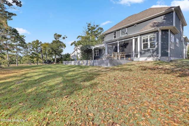 back of property featuring a lawn