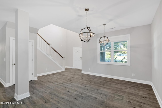 interior space with a notable chandelier and dark hardwood / wood-style flooring