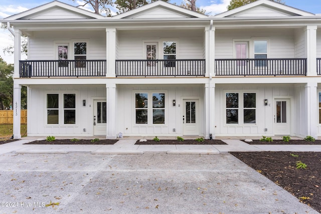 view of front of house featuring a balcony