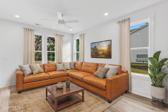 living room featuring light hardwood / wood-style flooring and ceiling fan