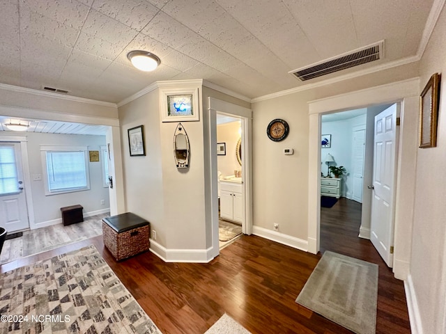 interior space with dark hardwood / wood-style floors and ornamental molding