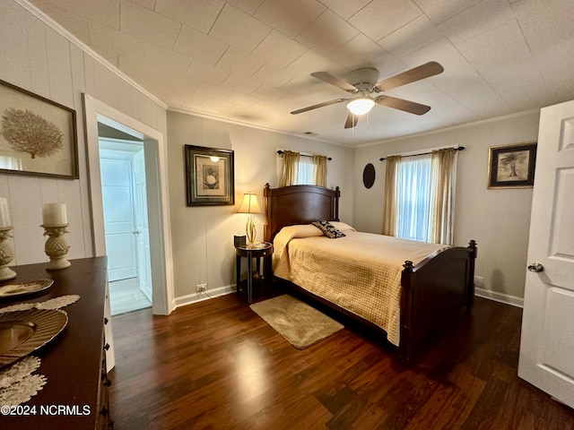 bedroom with ornamental molding, ceiling fan, and dark wood-type flooring