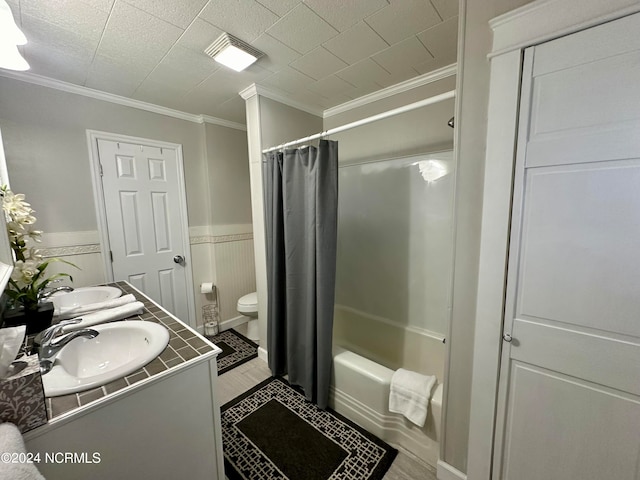 full bathroom featuring ornamental molding, shower / tub combo, vanity, and toilet