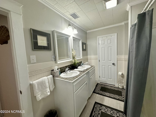 1118 W Main St, Belhaven, NC 27810 - bathroom with ornamental molding, double vanity, and a wainscoted wall