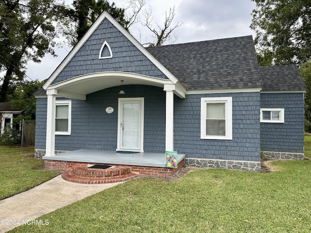 1118 W Main St, Belhaven, NC 27810 - view of front of property with covered porch, a front yard, and a shingled roof