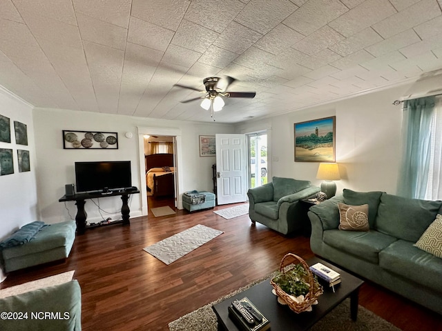 living room with dark hardwood / wood-style flooring and ceiling fan