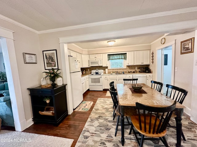 dining space featuring sink, crown molding, and dark hardwood / wood-style flooring