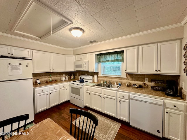 kitchen with dark hardwood / wood-style flooring, white appliances, and white cabinetry