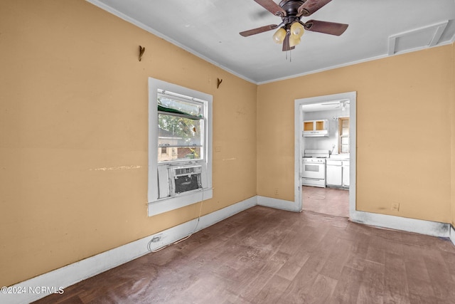 spare room featuring ceiling fan, ornamental molding, and wood-type flooring