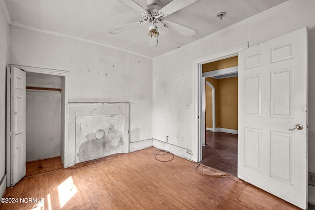 unfurnished bedroom featuring wood-type flooring, a closet, and ceiling fan