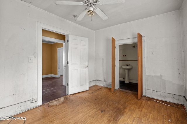 unfurnished bedroom featuring sink, ceiling fan, and hardwood / wood-style flooring