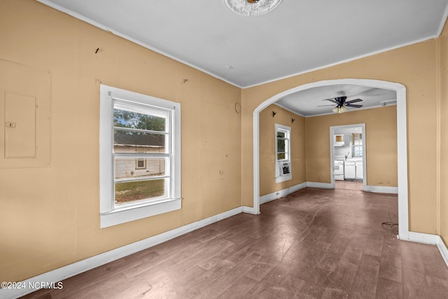 empty room with electric panel, ceiling fan, and hardwood / wood-style flooring