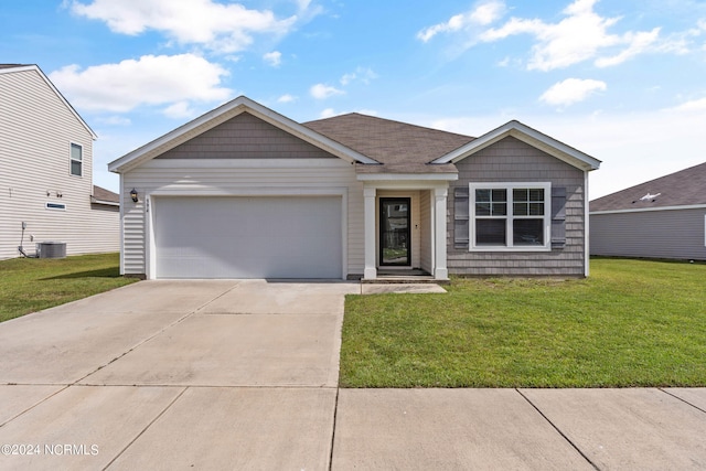 view of front of property featuring a front lawn, central AC, and a garage