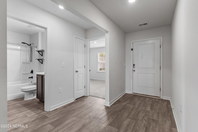 corridor with wood-type flooring