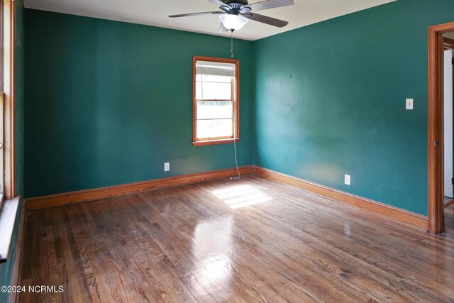 unfurnished room with ceiling fan and wood-type flooring