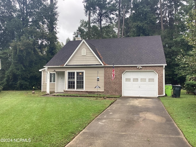 view of front of property featuring a front yard and a garage