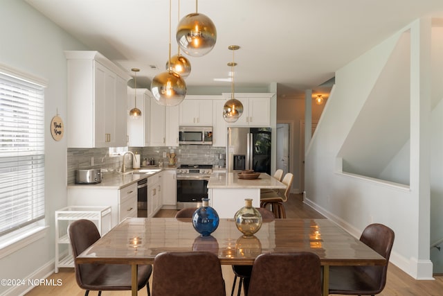 dining room featuring light hardwood / wood-style floors and sink