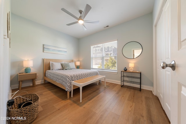 bedroom with ceiling fan, a closet, and hardwood / wood-style flooring