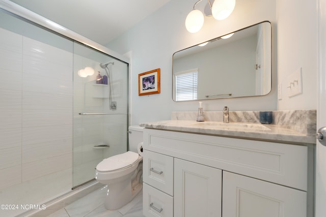 bathroom with walk in shower, vanity, and toilet